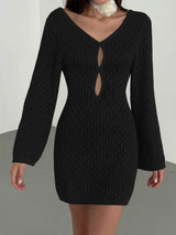 Woman wearing a black open knit mini dress with long sleeves and a keyhole neckline.