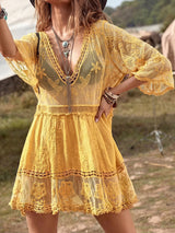 Woman wearing a yellow lace cover-up dress