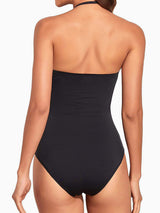 Back view of a woman wearing a black strapless one-piece swimsuit