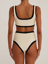 Woman wearing a cream and black ribbed bikini set, back view