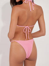 back view of a pink textured bikini with floral embellishments