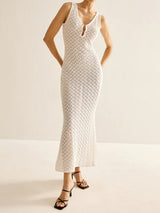 Woman wearing a white crochet knit maxi dress