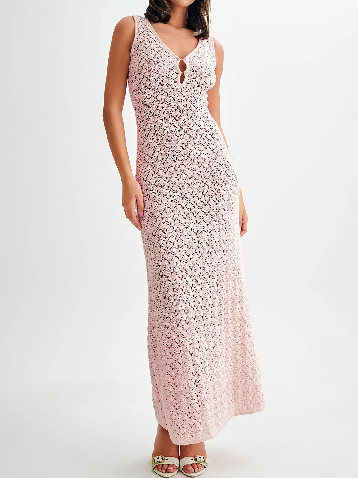 Woman wearing a light pink crochet knit maxi dress