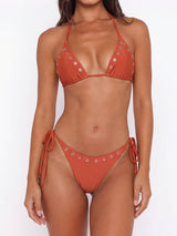 Front view of a rust-colored bikini set with grommet details
