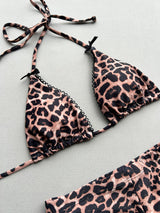 Close-up of the leopard print triangle bikini top with lace trim and bow accents.