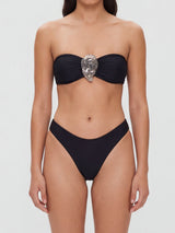 Front view of a black strapless bandeau bikini with a decorative accent on the bust and high-waisted bottoms.