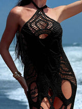 Close-up of a woman wearing a black crocheted maxi dress on a beach