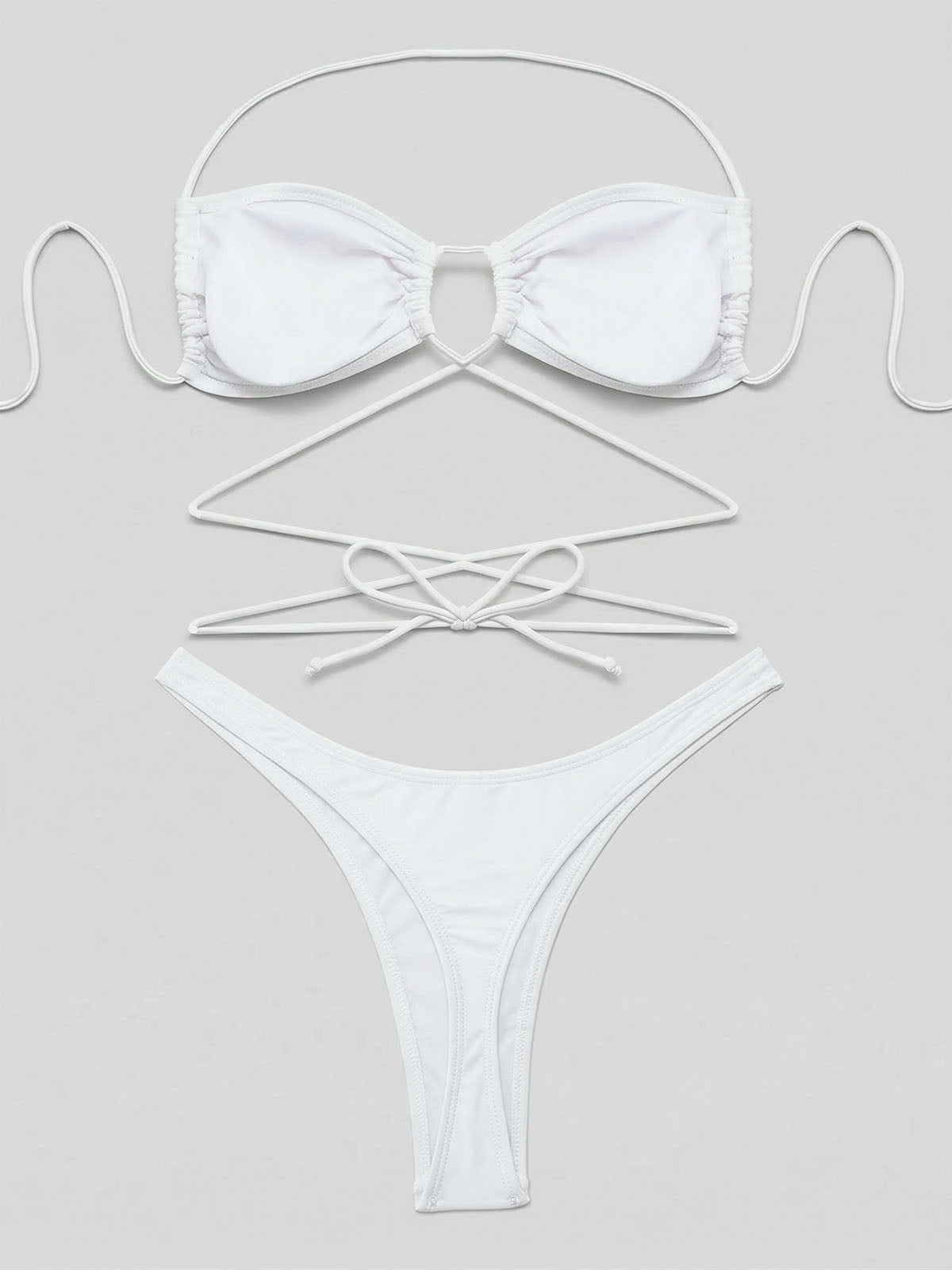 Flat lay of a white bikini set with detailed view of straps