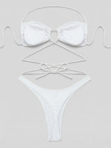 Flat lay of a white bikini set with detailed view of straps