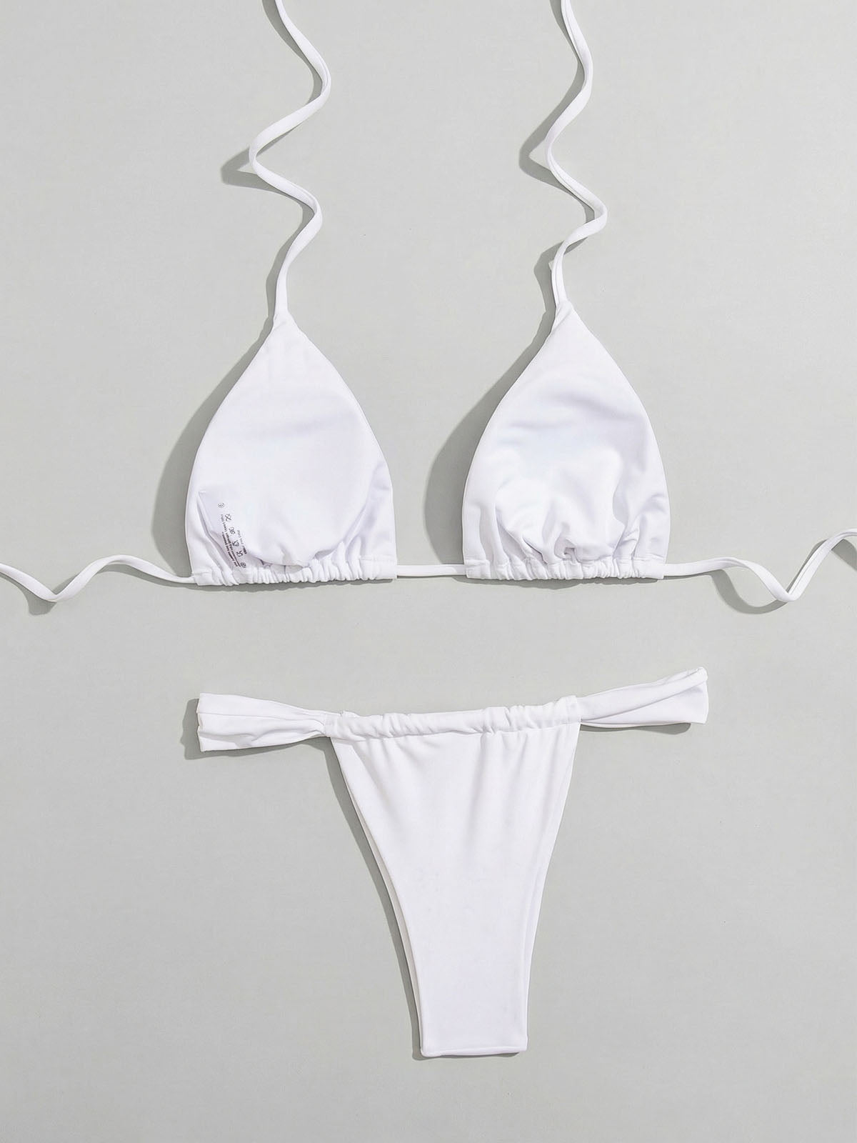 White ribbed bikini set laid flat, showing the reverse side of the top and bottom