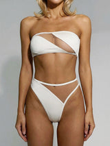 woman wearing a white strapless bikini with sheer panels and high-waisted bottoms
