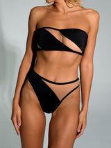 woman wearing a black strapless bikini with sheer panels and high-waisted bottoms