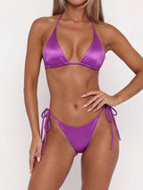Woman wearing a purple satin triangle bikini set with adjustable string ties