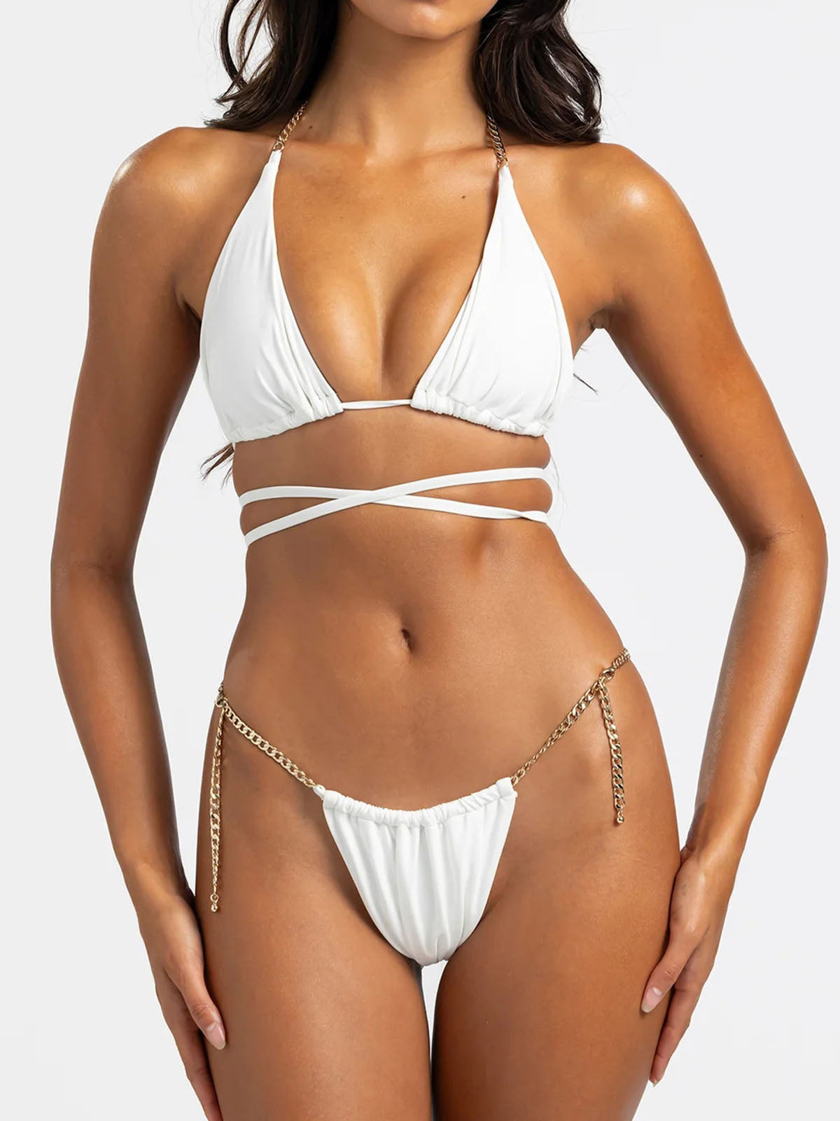 Front view of a white bikini with gold chain accents and wrap-around straps.