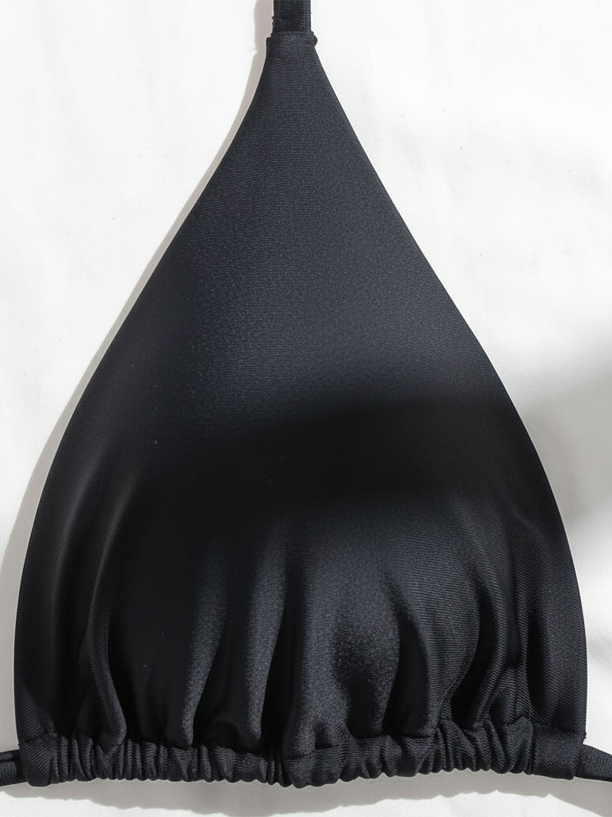 Close-up of the black bikini top triangle cup.