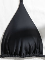 Close-up of the black bikini top triangle cup.