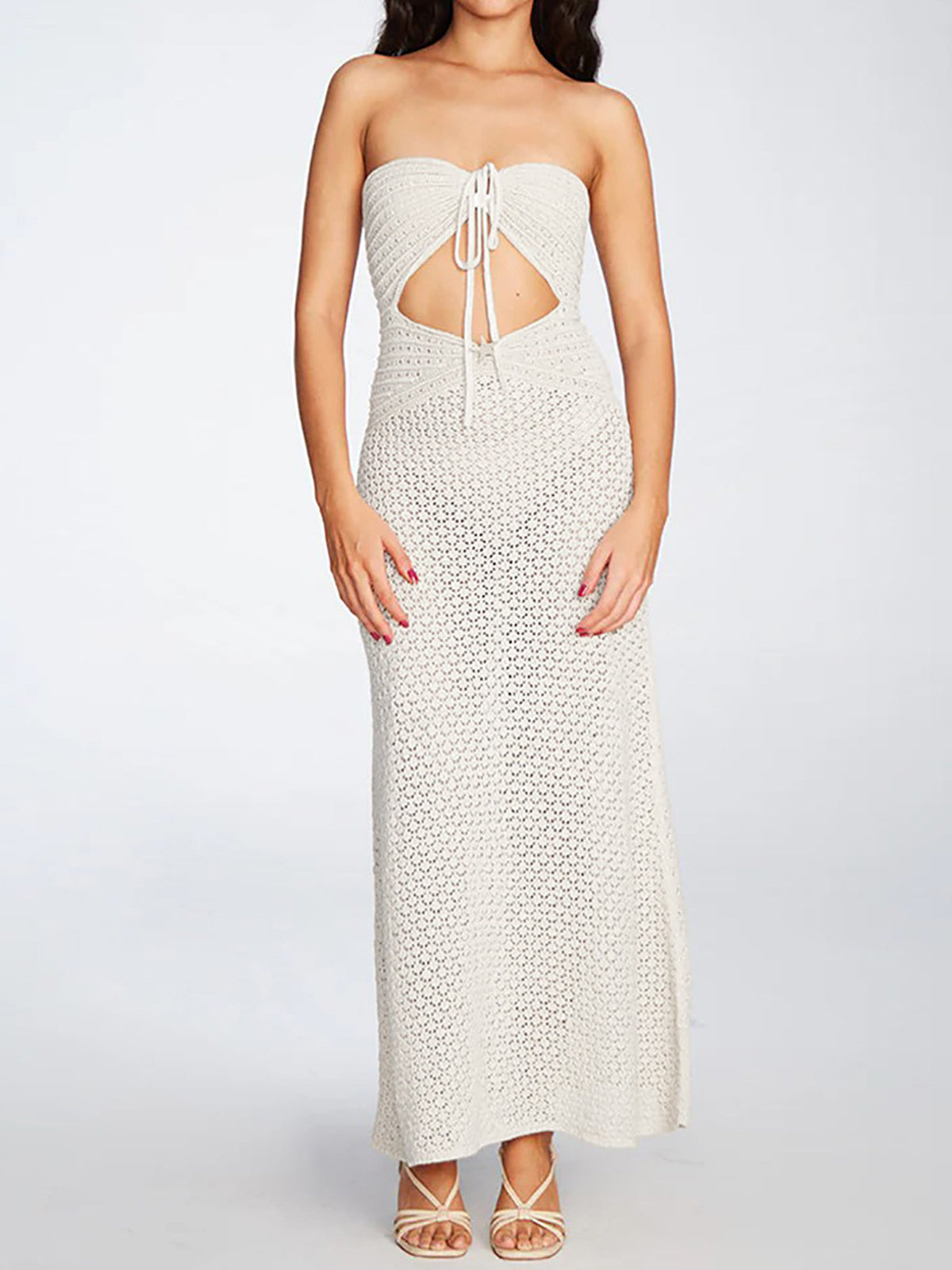 Woman wearing a cream crochet knit strapless maxi dress with a halter tie and cut-out detail